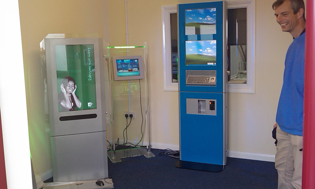 This 2 metre tall kiosk, comes with lower interactive 19'' display and a second, higher passive 19'' display for advertising purposes. At the rear of the unit a large passive of interactive third screen could replace the static advertisment area.